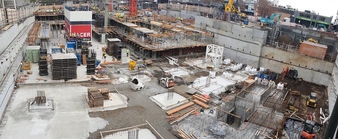 Wide view of a multi-level basement under construction